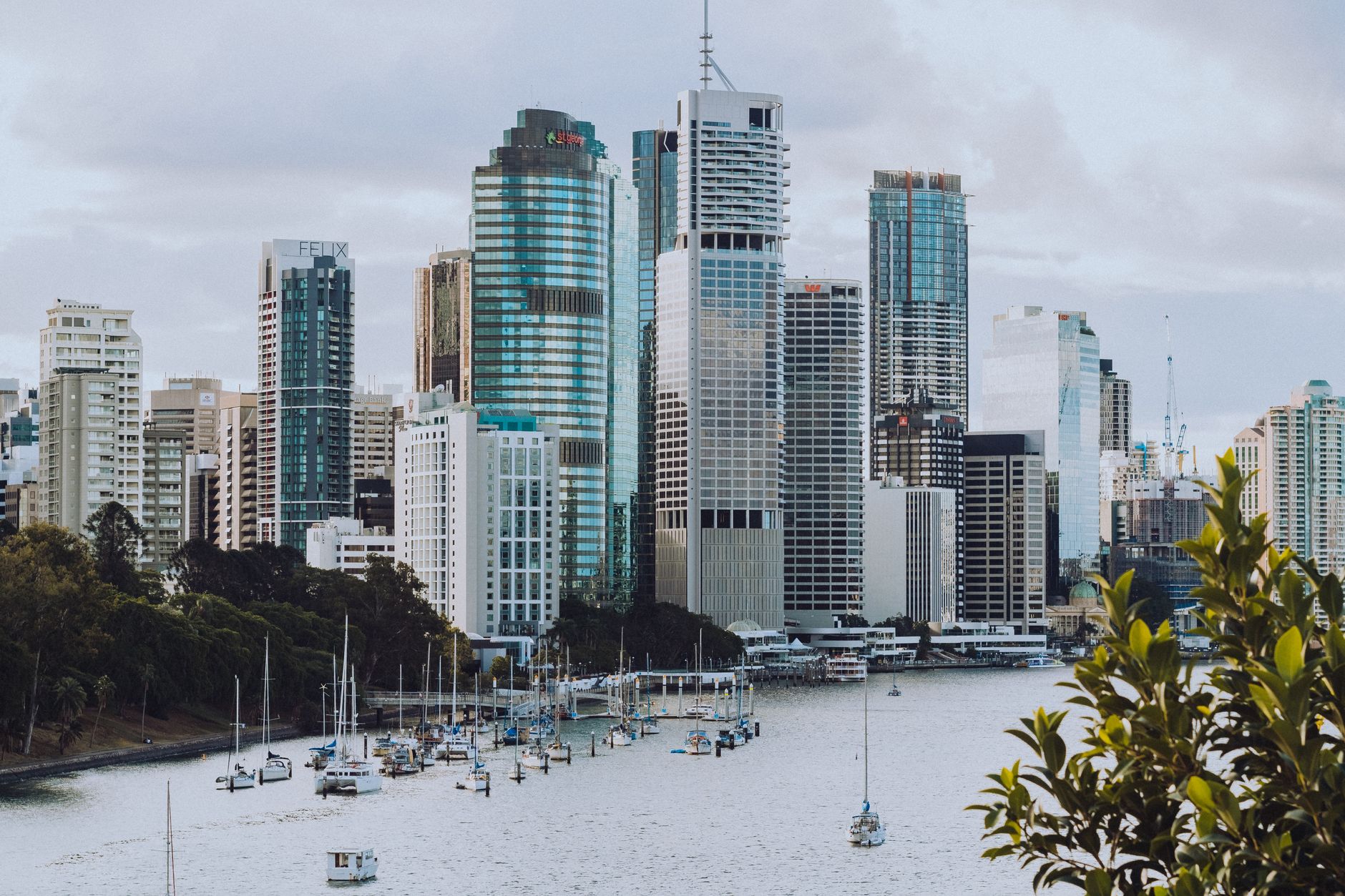 Brisbane skyline seen from the Brisbane River, with sailboats anchored