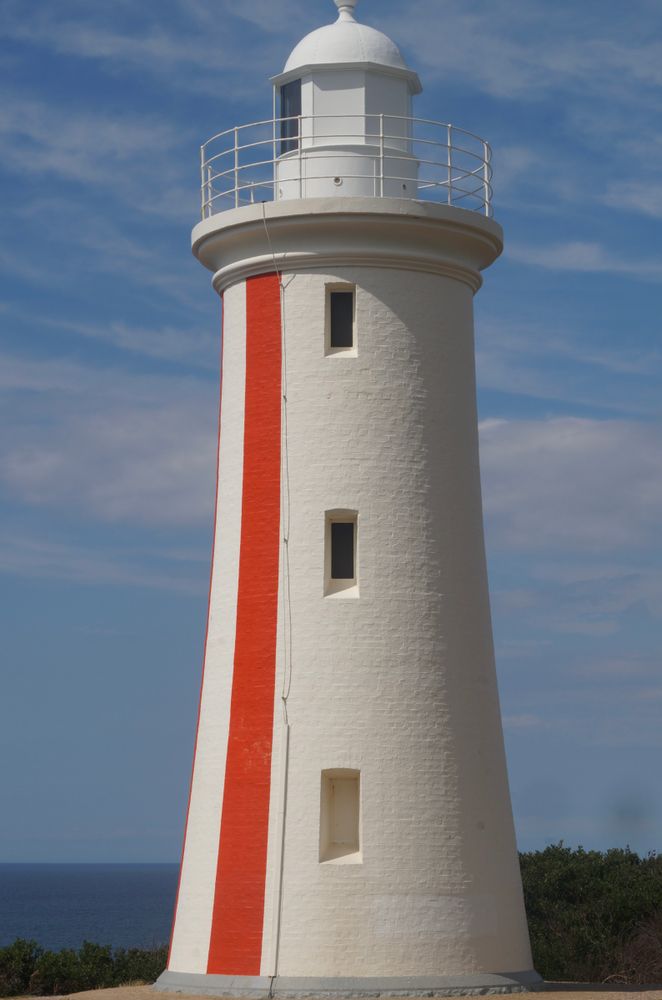 Mersey Bluff Lighthouse, white with a red stripe, in Devonport, Tasmania