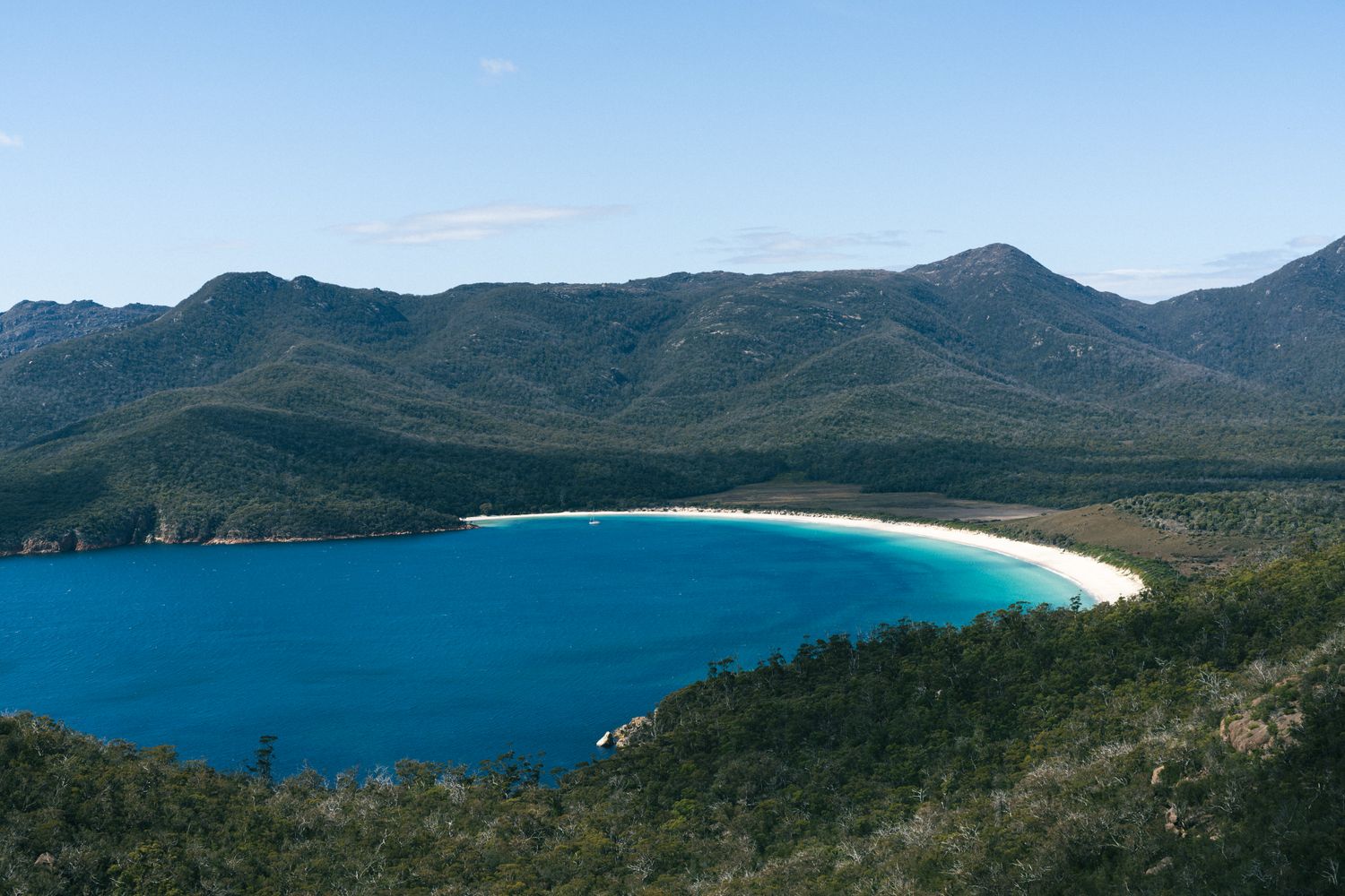View from the Wineglass Bay lookout, with the bay in its wine-glass shape, turquoise water and mountains around it